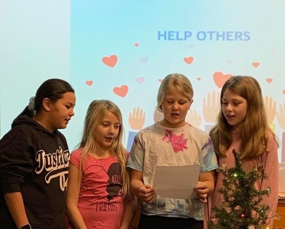 Fourth graders share their research about the charities they chose to donate to.